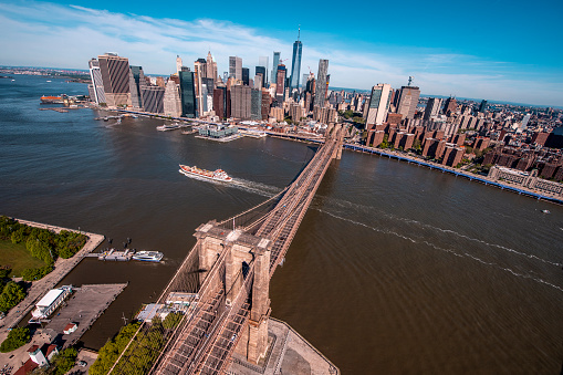 Aerial view of the Brooklyn Bridge reaching from Brooklyn over the East River to Downtown Lower Manhattan, taken from a helicopter.
