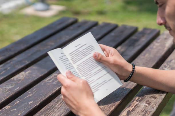 Men sit reading book in quiet nature, concept read a book.