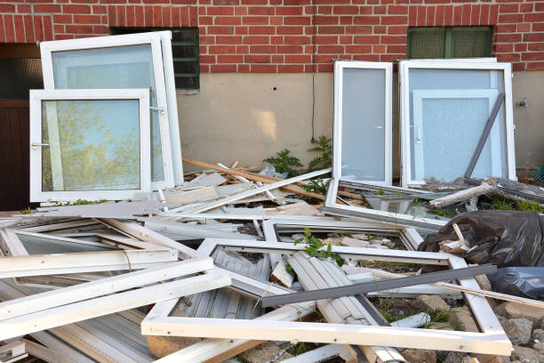 Many different construction debris from old plastic window frames of white color with glass. stock photo