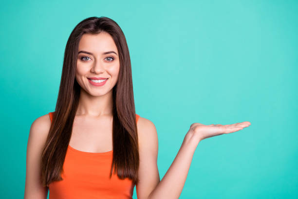 istock Portrait charming people millennial positive cheerful satisfied ad advertisement decision suggest present information sales discount news tip promoter concept modern clothing isolated green background 1152166088