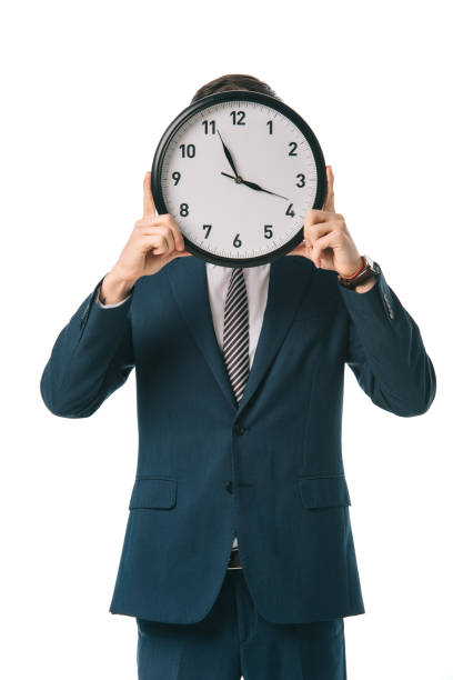 istock executive businessman holding clock in front of the face, isolated on white 1152166182