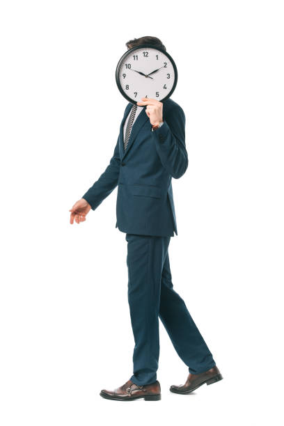 istock businessman in suit holding clock in front of the face while walking isolated on white 1152166202