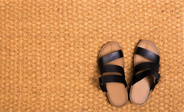 istock Cleaning foot carpet with sandals welcome home  - Image 1152166819