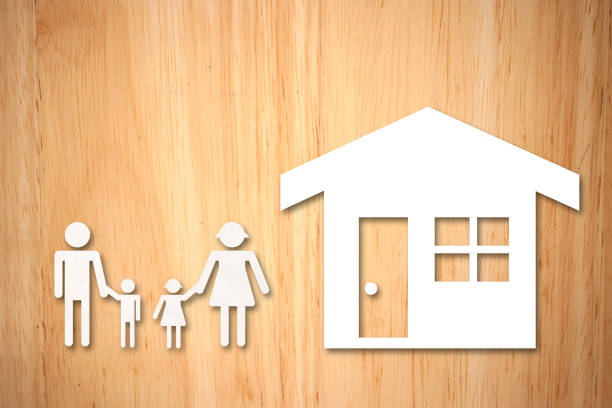 istock Human Representations And Model House On Wooden Table 1152167266