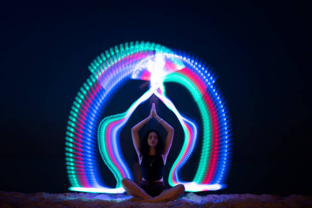 istock Young woman meditating in front of long tail light 1152167328