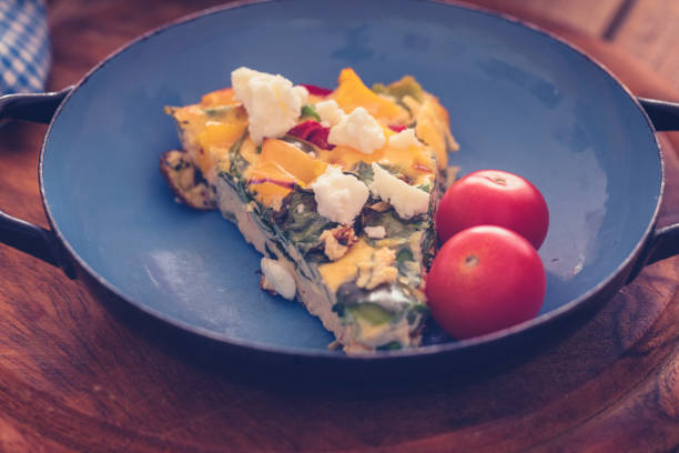 istock Frittata with baby spinach, bell peppers, cherry tomatoes and goat cheese 1152168011