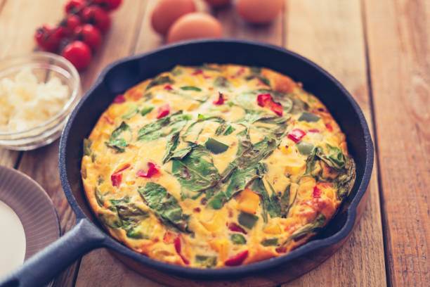 istock Frittata with baby spinach, bell peppers, cherry tomatoes and goat cheese 1152168284