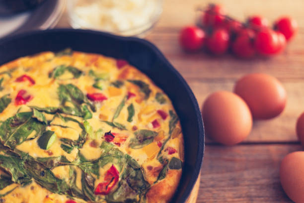 istock Frittata with baby spinach, bell peppers, cherry tomatoes and goat cheese 1152168429