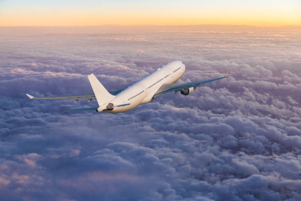 istock Passenger jet airplane flying above clouds at sunset 1152171755