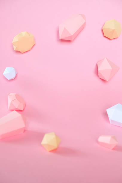 istock polygonal diamonds made of paper on a pink background 1152177894