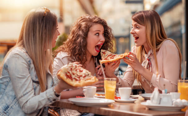 istock Girls having fun in cafe 1152181280