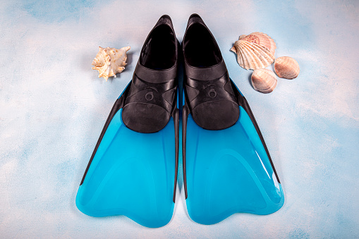 Pair of blue flippers (Diver Shoes) isolated on blue ground.