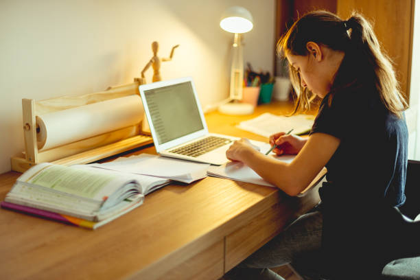 istock Teenager girl doing homework 1152182557