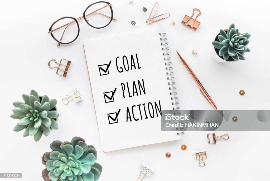 Goal,plan,action text on notepad with office accessories.Business motivation,inspiration,professional performance Goal,plan,action text on notepad with office accessories.Business motivation,inspiration,professional performance concepts Planning Stock Photo