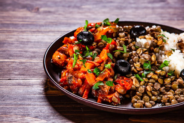 istock Rice and vegetables on wooden table 1152184473