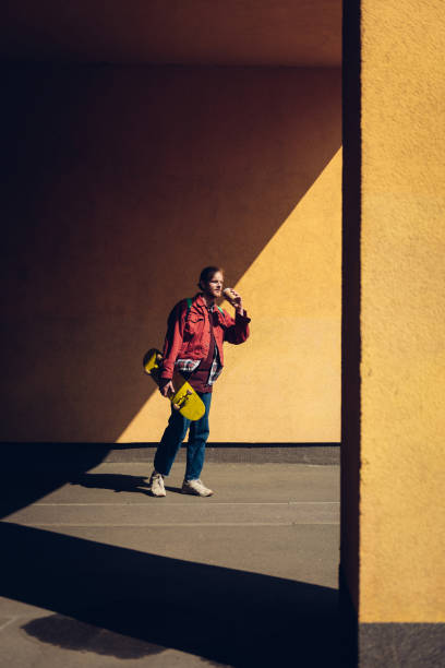 istock Young hipster man with skateboard and coffee 1152185334