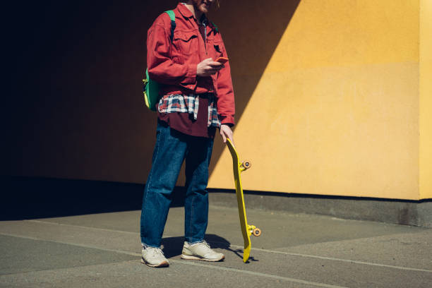 istock Hipster skater man looking at mobile phone 1152185360