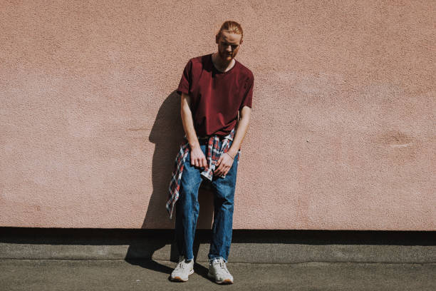 istock Young hipster man leaning on building wall 1152185430