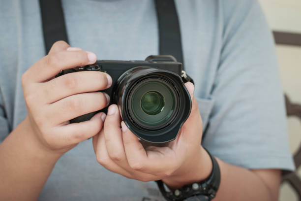 istock Professional young photographer working concentrate adjusts new mirrorless camera before shooting or take photo, lens focus. Hobby creative equipment concept 1152187653