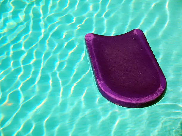 Purple kickboard in swimming pool