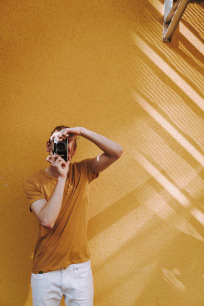 istock Young casual man making photo on camera 1152188253