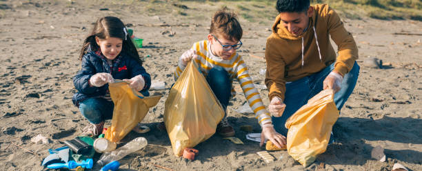 istock Young volunteers cleaning the beach 1152189866