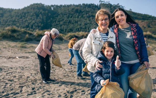 istock Female volunteers cleaning the beach 1152189870