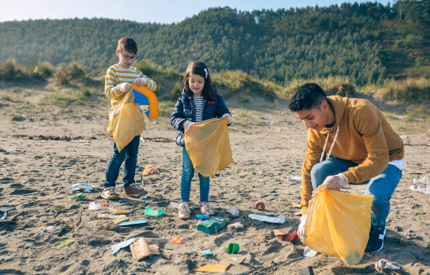 istock Young volunteers cleaning the beach 1152189889