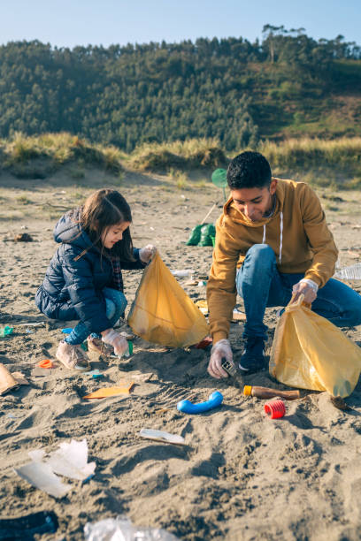 istock Young volunteers cleaning the beach 1152189895