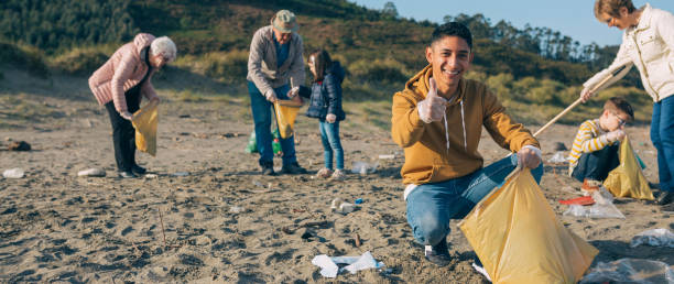 istock Young man cleaning the beach 1152189915
