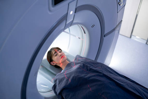 hohe winkelansicht des patienten, der für den mrt-scan liegt - magnetresonanztomographie stock-fotos und bilder