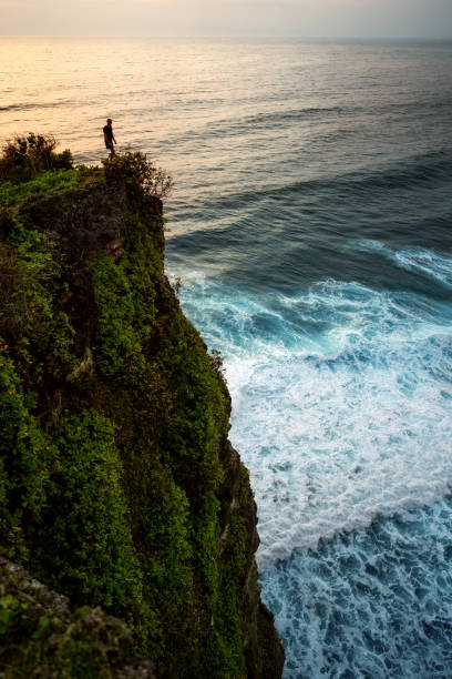 istock tourist guy stands on a mountain 1152193259