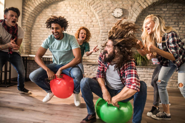 istock Cheerful colleagues having fun during space hopper at casual office. 1152195160