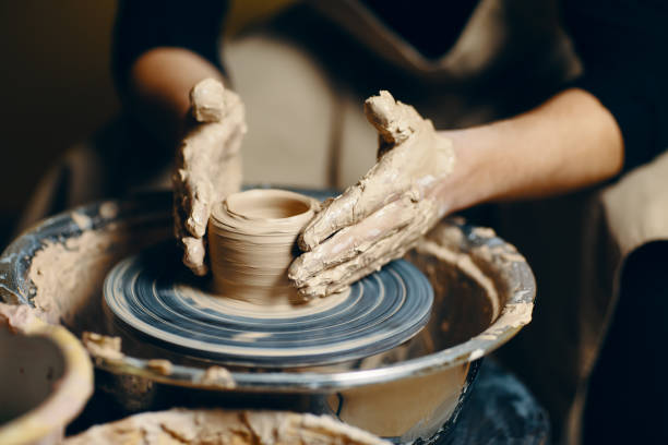 istock Modeling of clay on a potter's wheel in the pottery workshop 1152196559