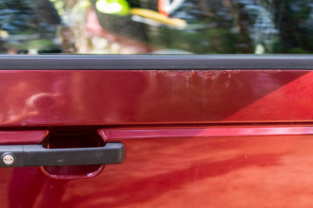 istock Rust visible on the door of a red car. 1152197562