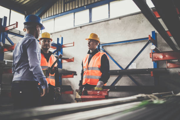 istock Manual workers talking to quality control inspector in aluminum mill. 1152198079