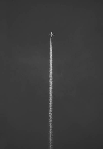 istock Vapor trail behind flying airplane 1152198958