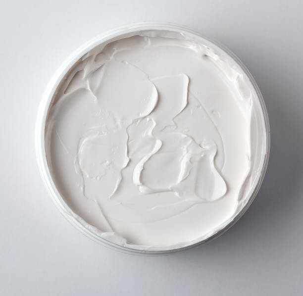 istock thick white cosmetic cream in a plastic jar, top view 1152199172