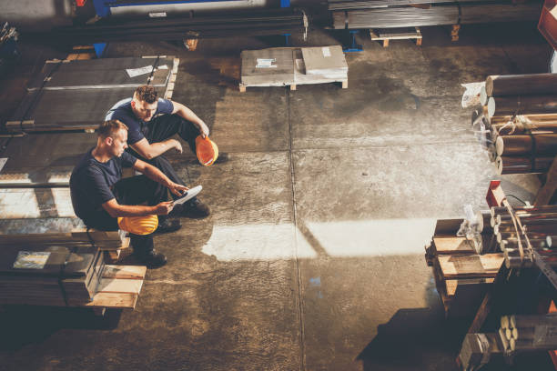 istock Above view of manual workers working on documents during a break in steel mill. 1152199532