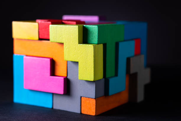 Cube made of multicolored wooden geometric shapes. Concept of decision making process, creative, logical thinking. Choose correct answer. Logical tasks. Conundrum.
