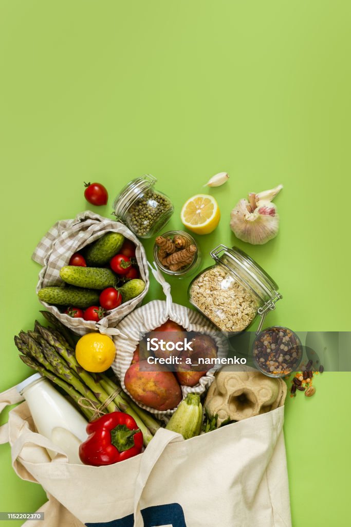 Zero waste shopping concept - groceries in textile bags and glass jars Zero waste shopping concept - groceries in textile bags and glass jars, top view Flat Lay Stock Photo