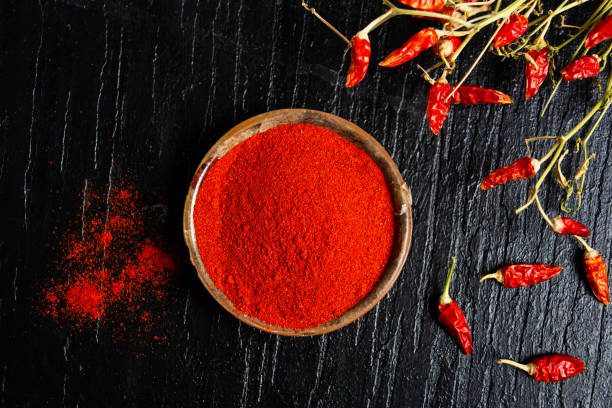 Grounded red paprika in a bowl Grounded red paprika spice in a bowl cayenne powder stock pictures, royalty-free photos & images