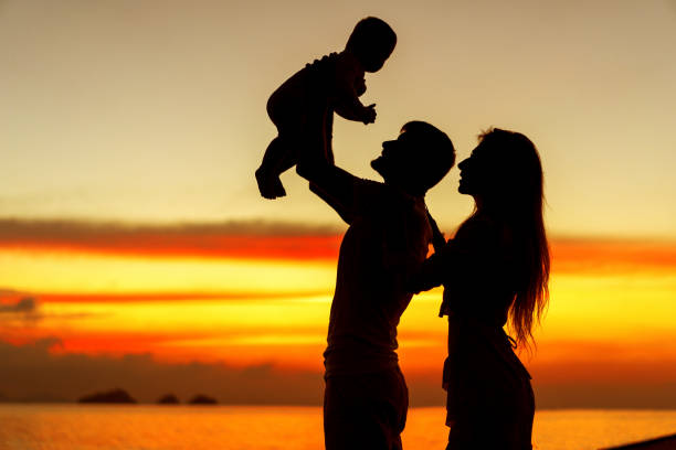 istock Family in love with son hugging at sunset, silhouette 1152202814