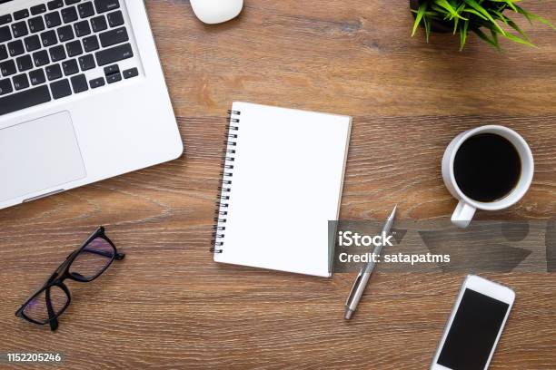 Desk, gadgets and office supplies. Flat lay. Wooden desk. Stock Photo by  halfpoint