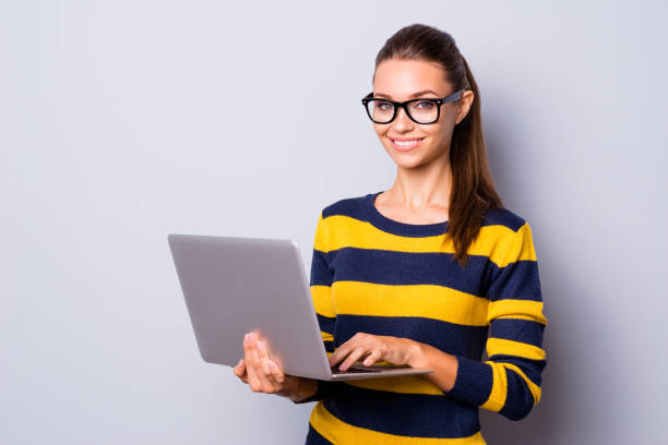 Portrait positive inspired lady youth hold hand device wireless connection user programs university studying learning texting woolen spring nice striped sweater stylish outfit isolated grey background