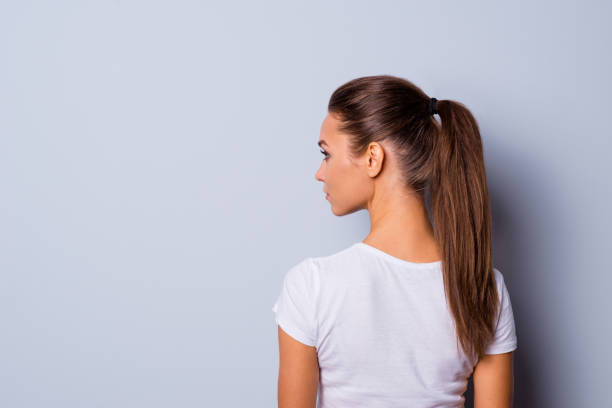 Close up back rear behind side profile view photo amazing beautiful she her lady look side empty space not smiling reliable person wear casual white t-shirt clothes isolated grey background Close up back rear behind side profile view photo amazing beautiful she her lady look side empty space not smiling reliable person wear casual white t-shirt clothes isolated grey background. ponytail stock pictures, royalty-free photos & images