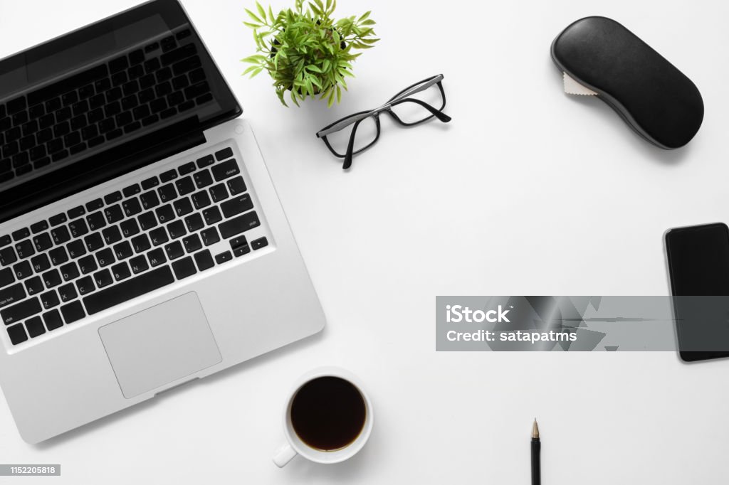 White Office Desk Table With Laptop Computer Cup Of Coffee And Office  Supplies Top View With Copy Space Flat Lay Stock Photo - Download Image Now  - iStock