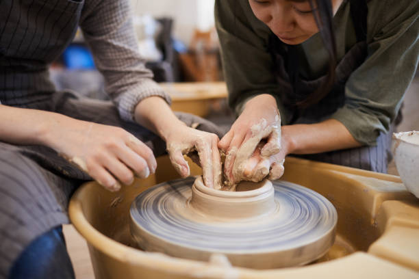 istock Showing how to mould clay dish 1152207956