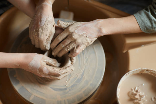 istock Moulding clay together on pottery wheel 1152207969