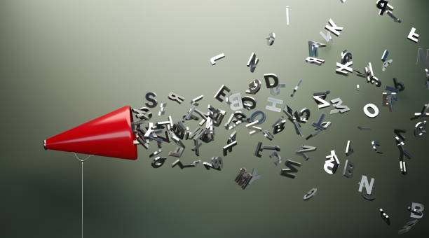 Red Megaphone And Silver Alphabet Letters In Front Of Gray Wall